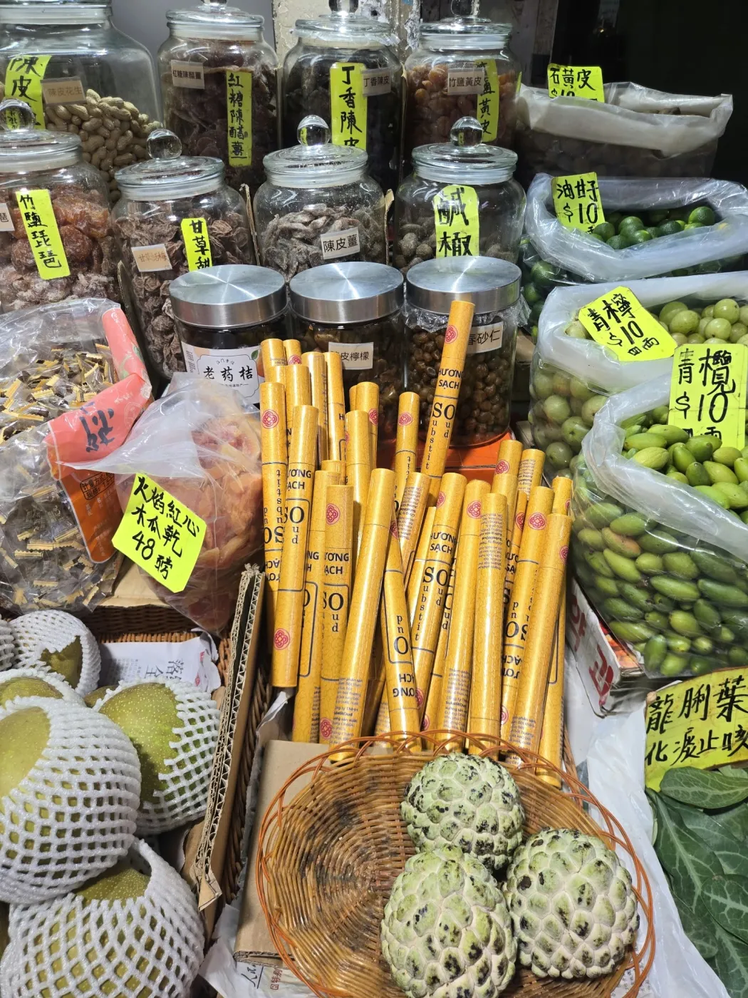 SubstitOud incense tubes among dried goods at a Hong Kong stall